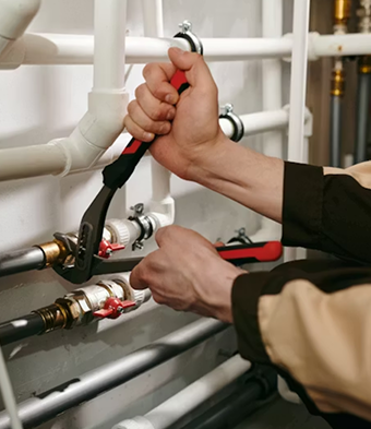 Plumber working on pipes